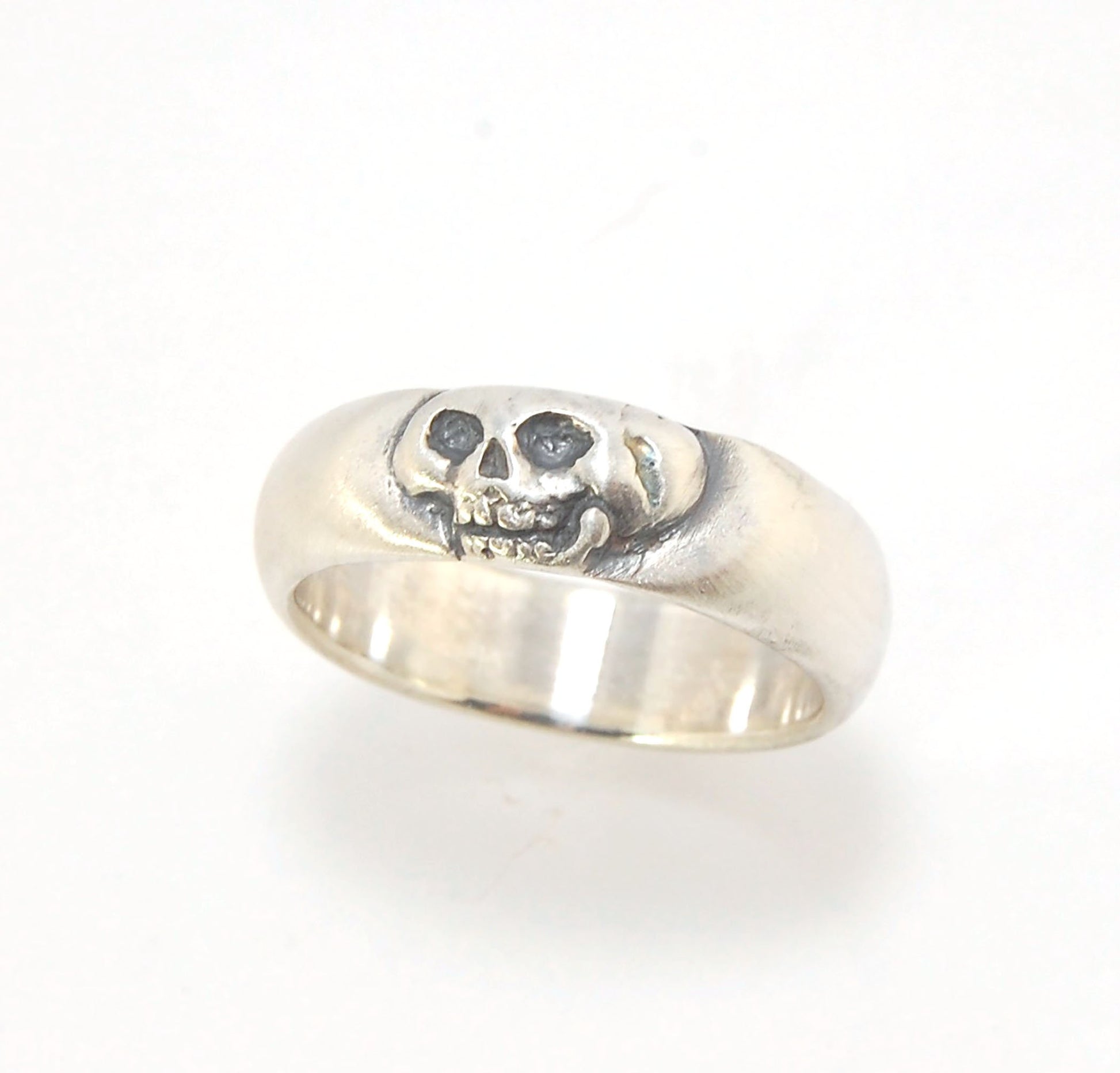 Memento Mori Skull Ring - Wide This is the widest of my Memento Mori skull rings at 7mm. Cast in sterling silver and given a brushed finish after oxidizing the recesses of the skull. Heavyweight, very comfortable.SterlingI made these Memento Mori rings fo