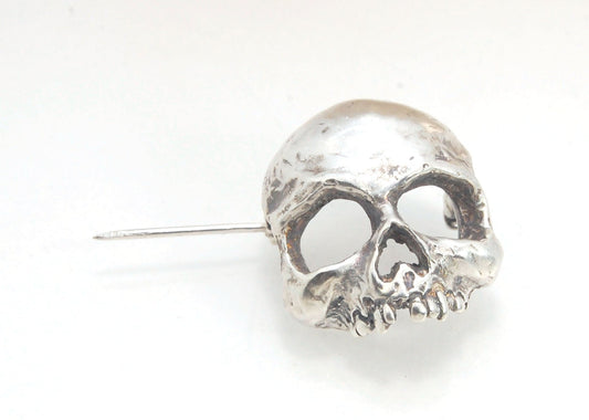 Through the Veil Darkly Skull Face Pin This Through the Veil Darkly Skull Face pin in Sterling Silver has a lot of expression and a nice weight with a hinged pin stem and clasp. It’s not too big or too small or too heavy. It will look great on your sweate