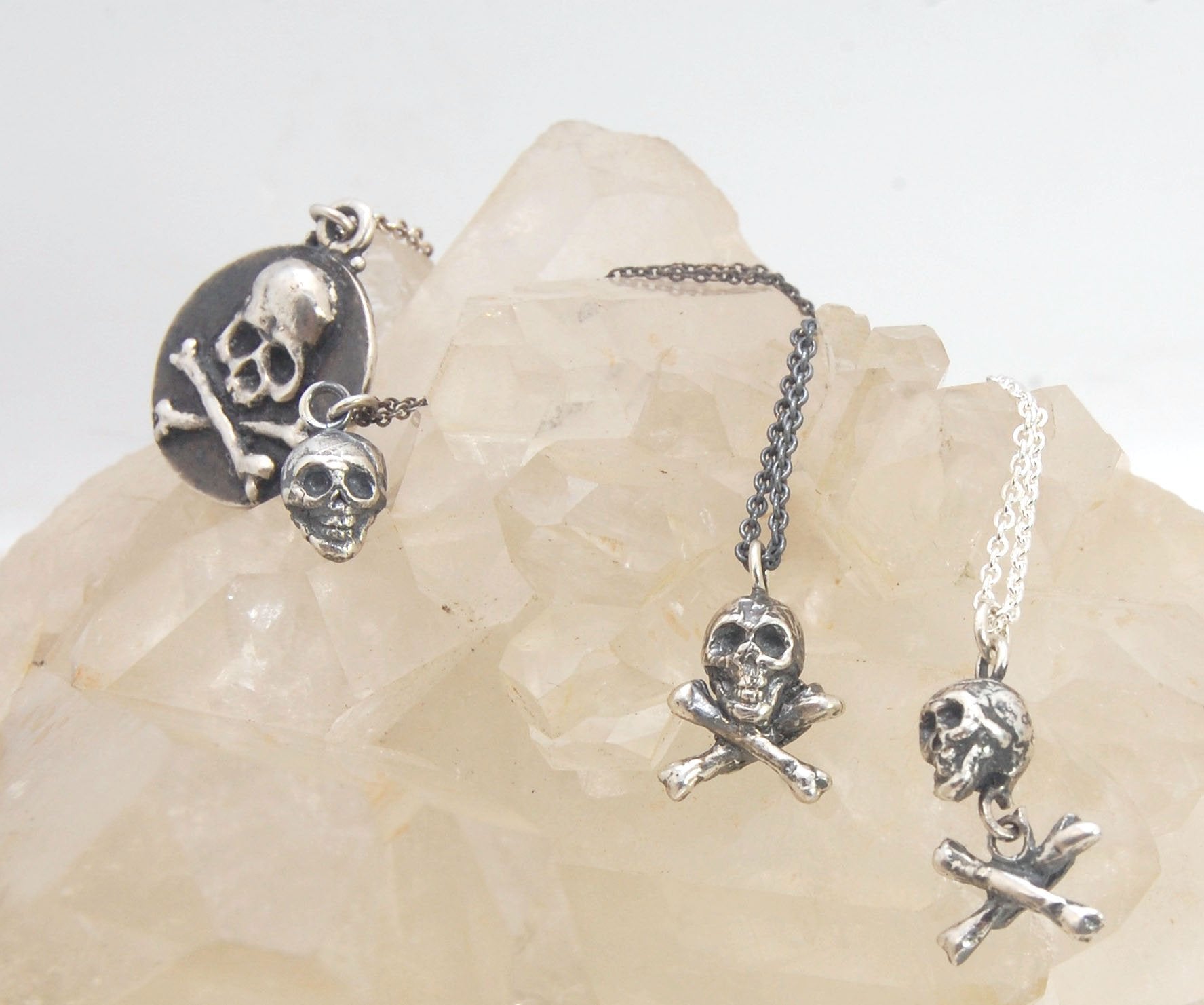 Tiny Skull Charm Pendant This solid sterling silver Skull Pendant is wax carved by hand and cast using the ancient process of Lost Wax casting. I then made a mold, which I can inject with wax and make wax copies of the Jolly Roger Pendant and cast a lot o