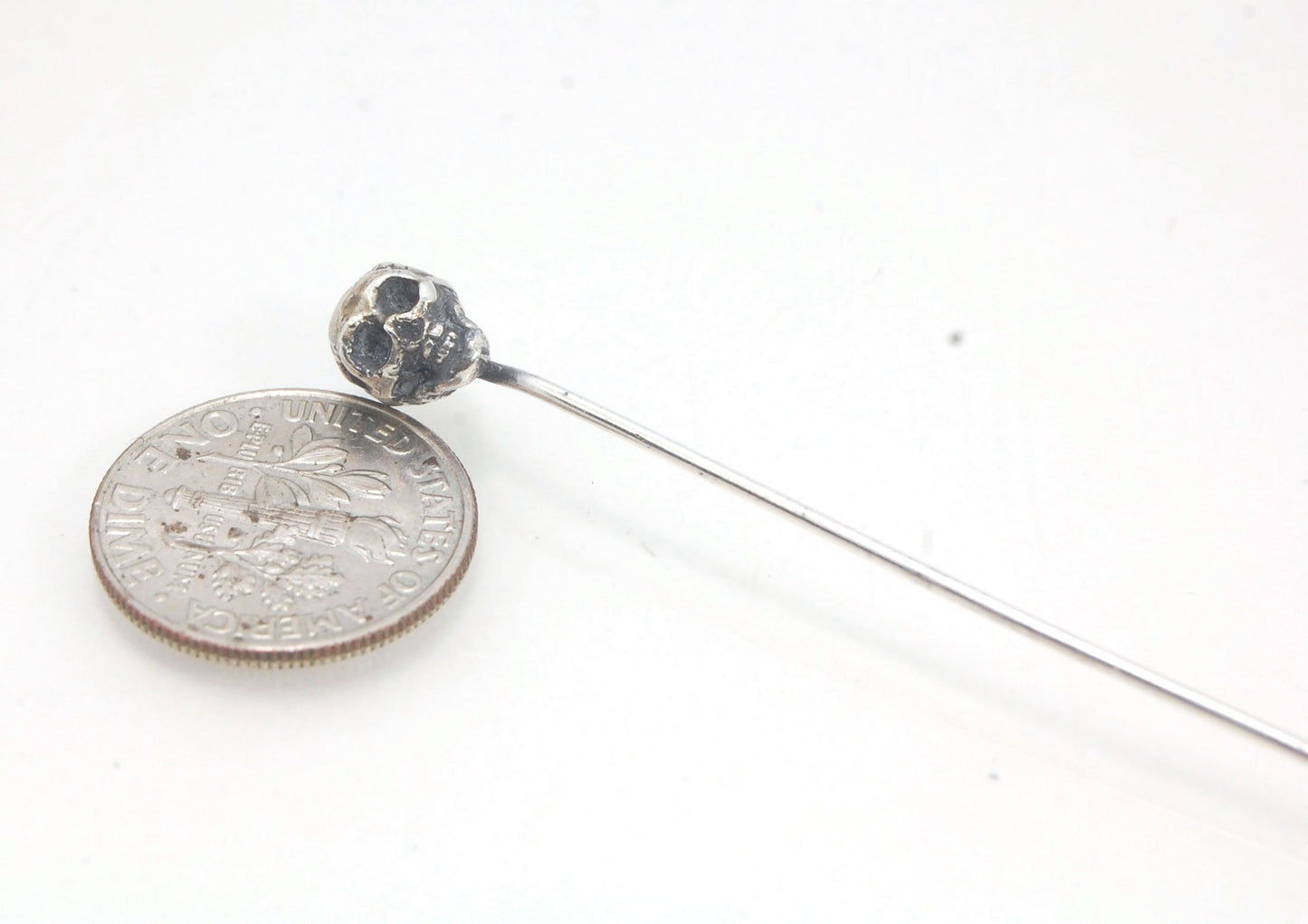 Yorick Skull Stick Pin This Skull Stick Pin is just darling if you like weird stuff. This Skull is wax carved by hand and cast using the ancient process of Lost Wax to cast them in sterling silver. I then made a mold, which I can inject with wax and make