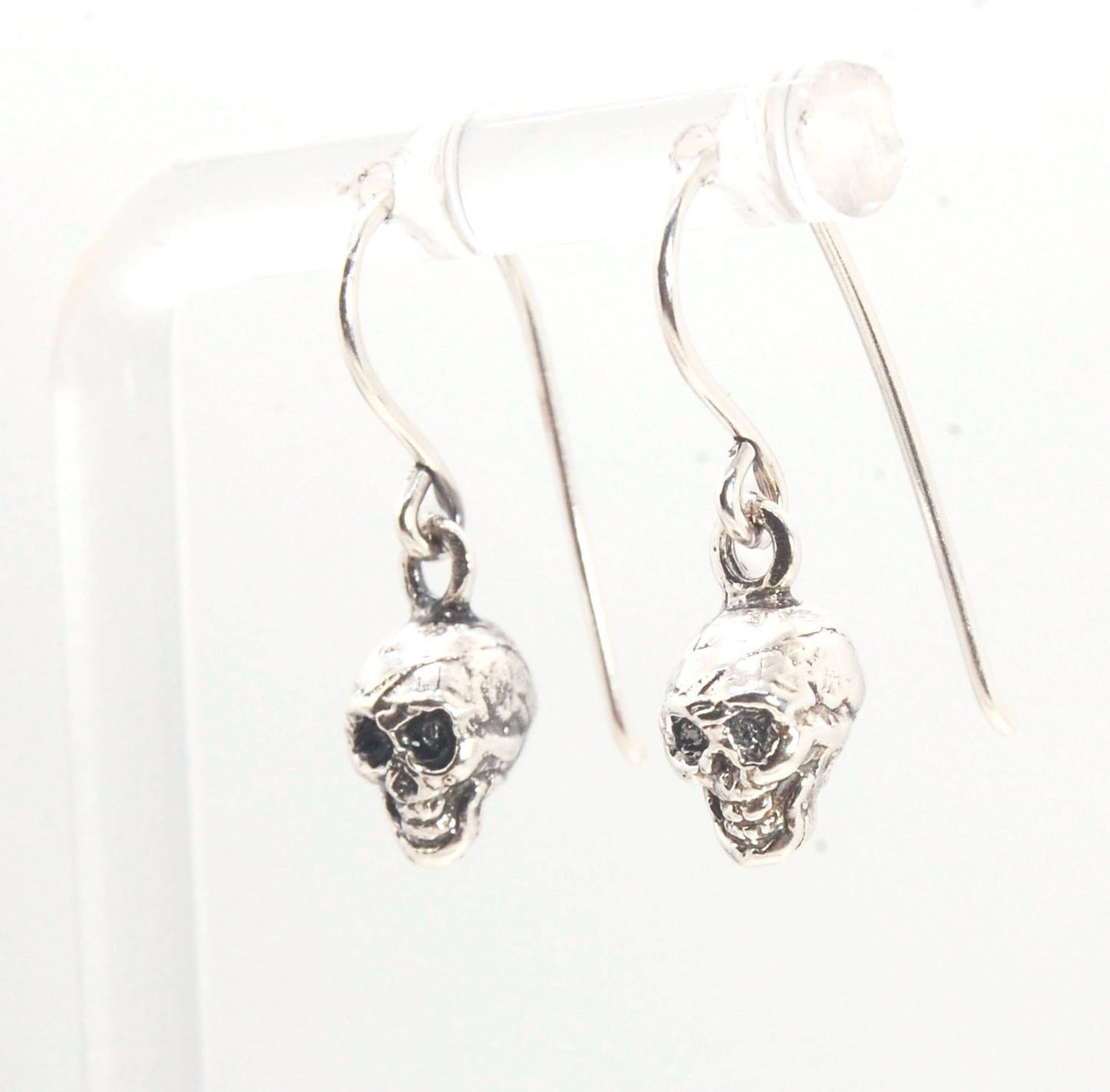 Skull Dangle Earrings This solid sterling silver Skull Pendant is wax carved by hand and cast using the ancient process of Lost Wax casting. I then made a mold, which I can inject with wax and make wax copies of the Jolly Roger Pendant and cast a lot of t