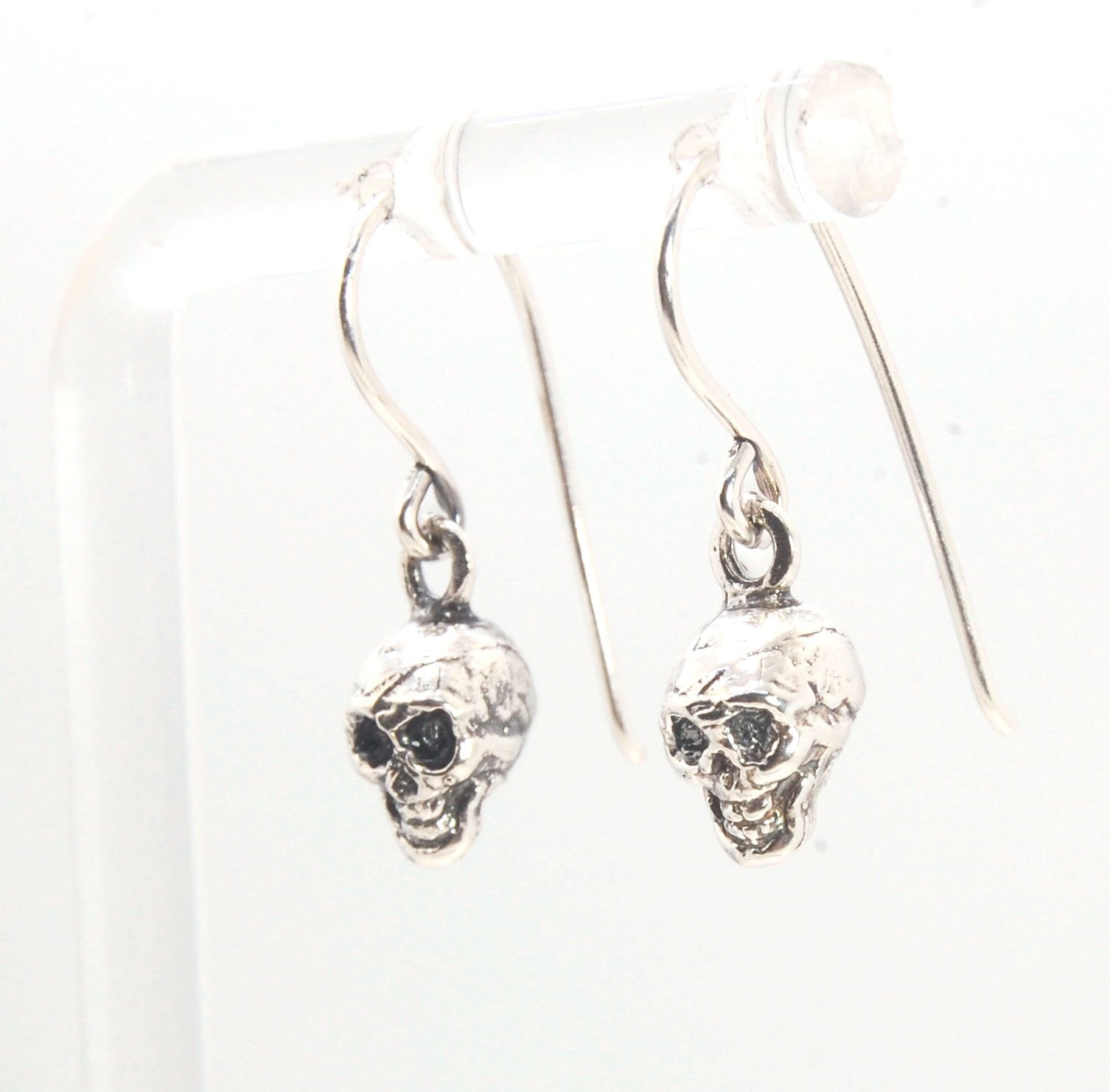 Skull Dangle Earrings This solid sterling silver Skull Pendant is wax carved by hand and cast using the ancient process of Lost Wax casting. I then made a mold, which I can inject with wax and make wax copies of the Jolly Roger Pendant and cast a lot of t