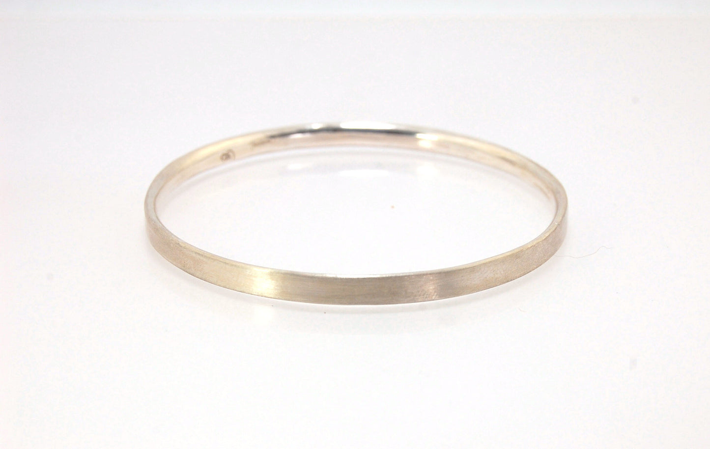 5mm Inverted Half Round Sterling Silver Bangles Who doesn’t love a good bangle stack! These comfortable inverted half round bangles are available in 2 finishes. Shiny or Matte.Handmade by me in my studio, I pour a large ingot of sterling silver and roll i