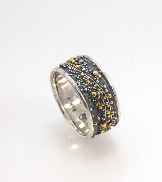 Cosmic Waves 18k and Fine Silver Granulation Ring 11mm wide This is very similar to the ring I made during the segment of “A Craftsman’s Legacy” on PBS a few years ago but with 18k gold granules of varying sizes. I am happy to make one for you in your siz