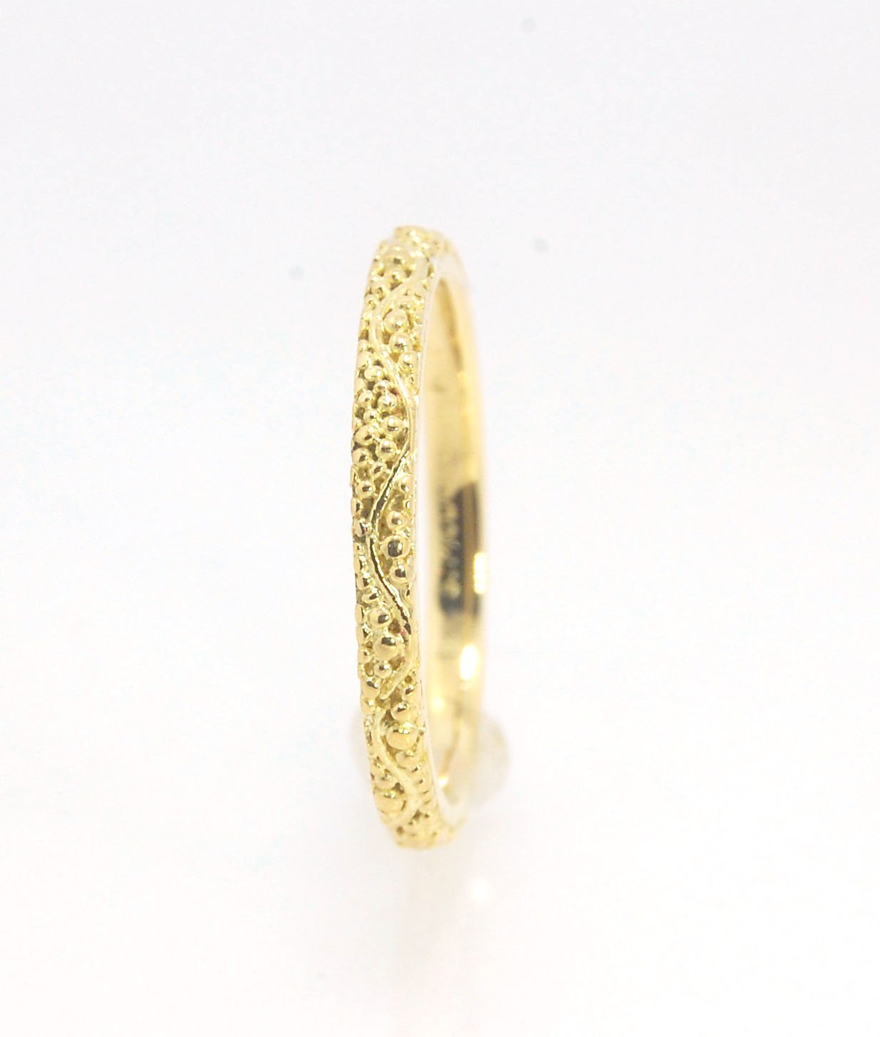 Twining Band in 18k Granulation This is a one-of-a-kind 18k ring handmade using the ancient process of granulation. The twining band is 2mm wide and has a continuous pattern around made with an ancient and unique process of granulation in 18k gold alloyed