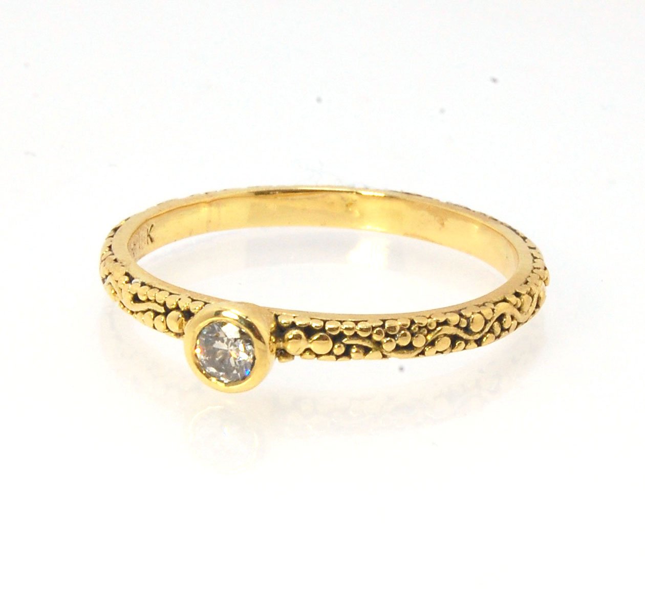 Twining Band Diamond Solitaire Ring in 18k Granulation This is a one-of-a-kind solitaire 18k ring. The twining band is 2mm wide and has a continuous pattern around made with an ancient and unique process of granulation in 18k gold alloyed in my studio. Th