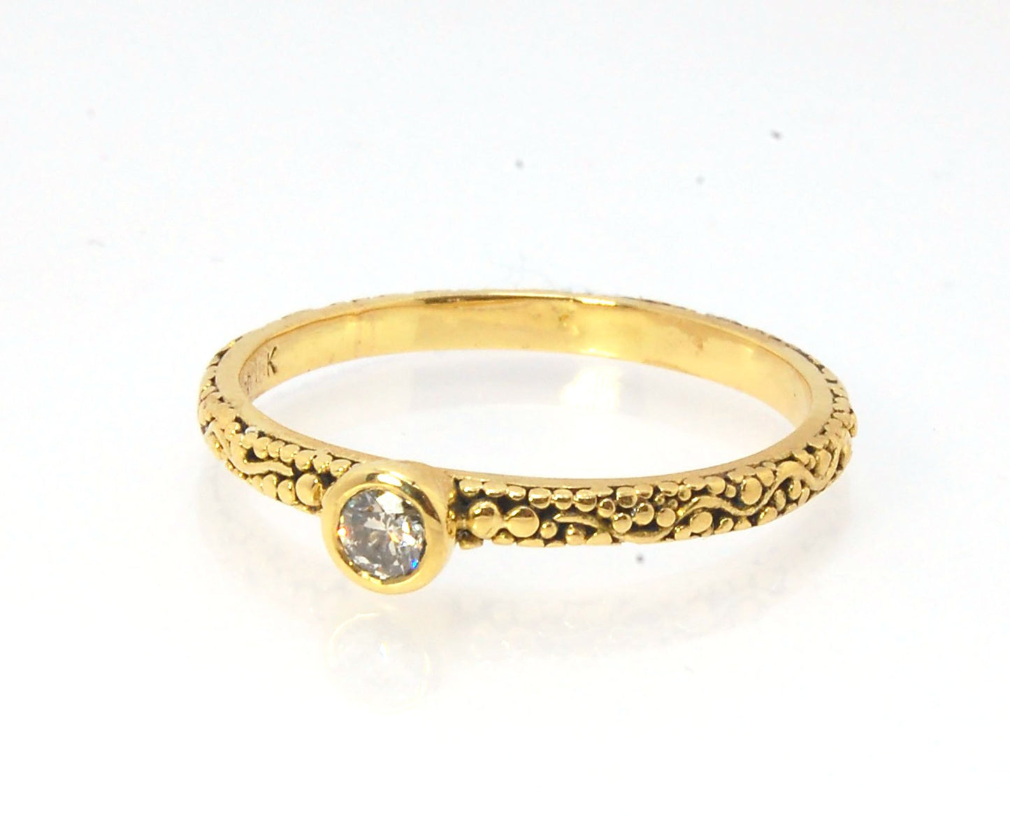 Twining Band Diamond Solitaire Ring in 18k Granulation This is a one-of-a-kind solitaire 18k ring. The twining band is 2mm wide and has a continuous pattern around made with an ancient and unique process of granulation in 18k gold alloyed in my studio. Th