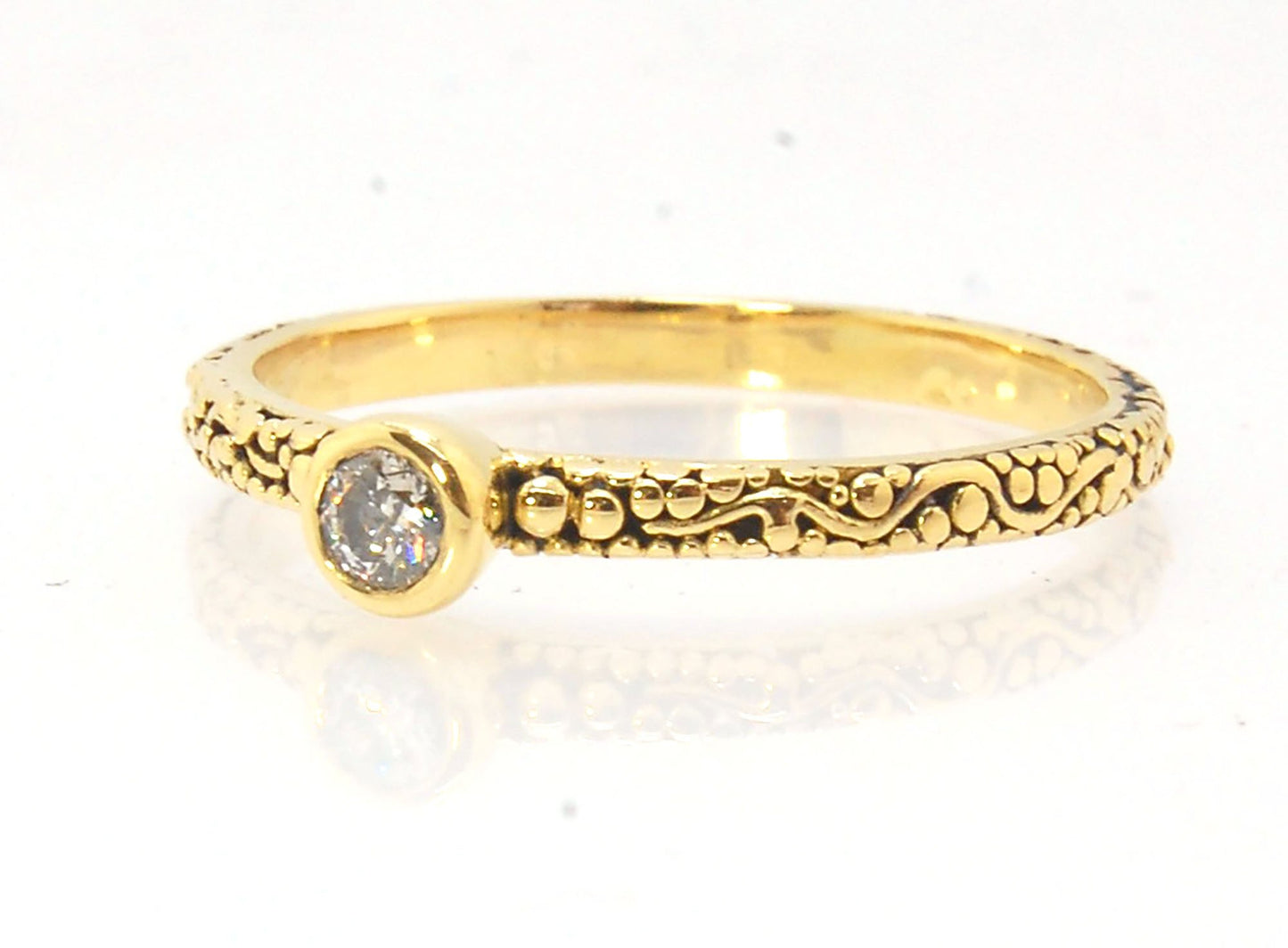 Twining Band Diamond Solitaire Ring in 18k Granulation This is a one-of-a-kind solitaire 18k ring. The twining band is 2mm wide and has a continuous pattern around made with an ancient and unique process of granulation in 18k gold alloyed in my studio. Th