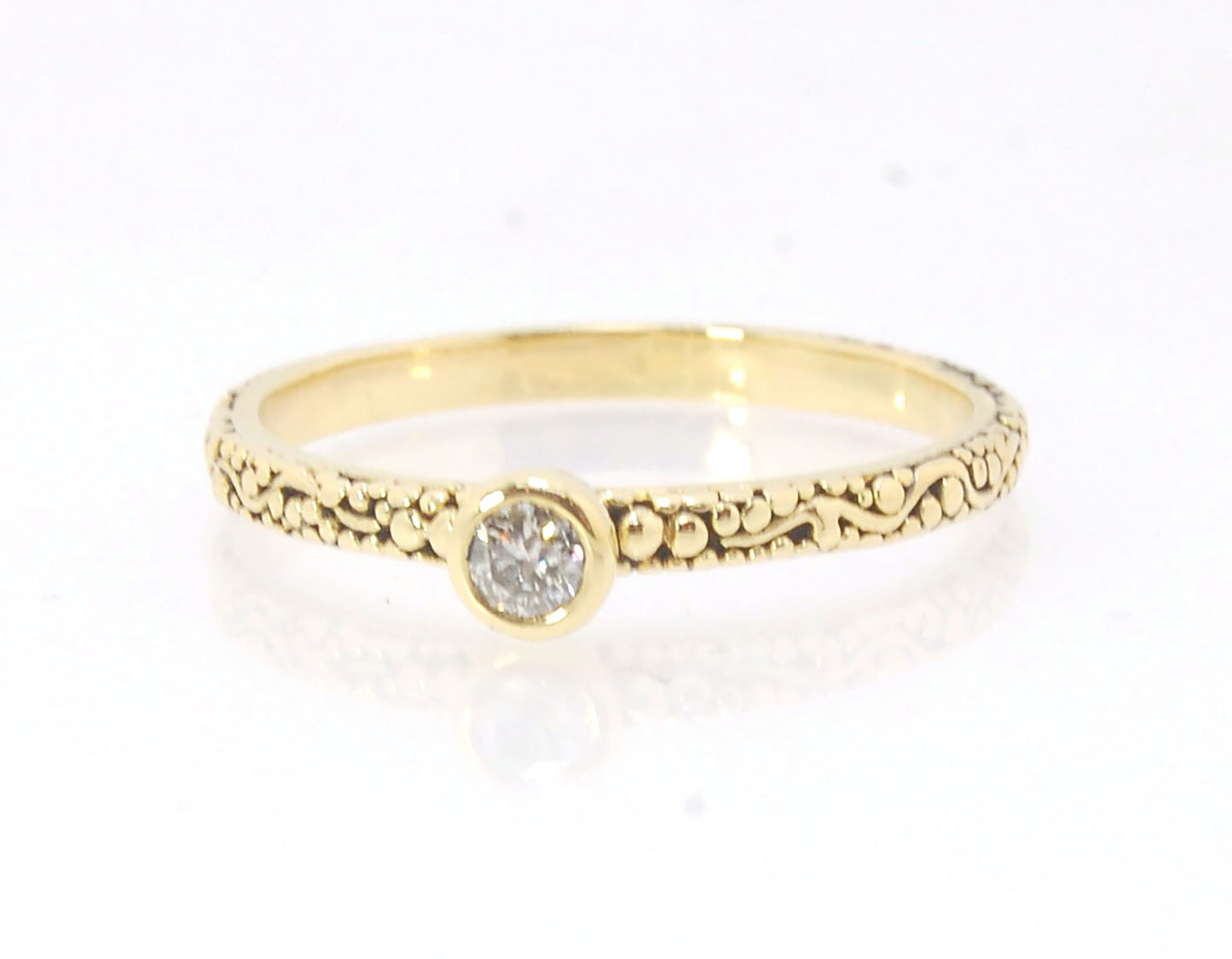 Twining Band Diamond Solitaire Ring in 18k Granulation This is a one-of-a-kind solitaire 18k ring. The twining band is 2mm wide and has a continuous pattern around made with an ancient and unique process of granulation in 18k gold alloyed in my studio. Th