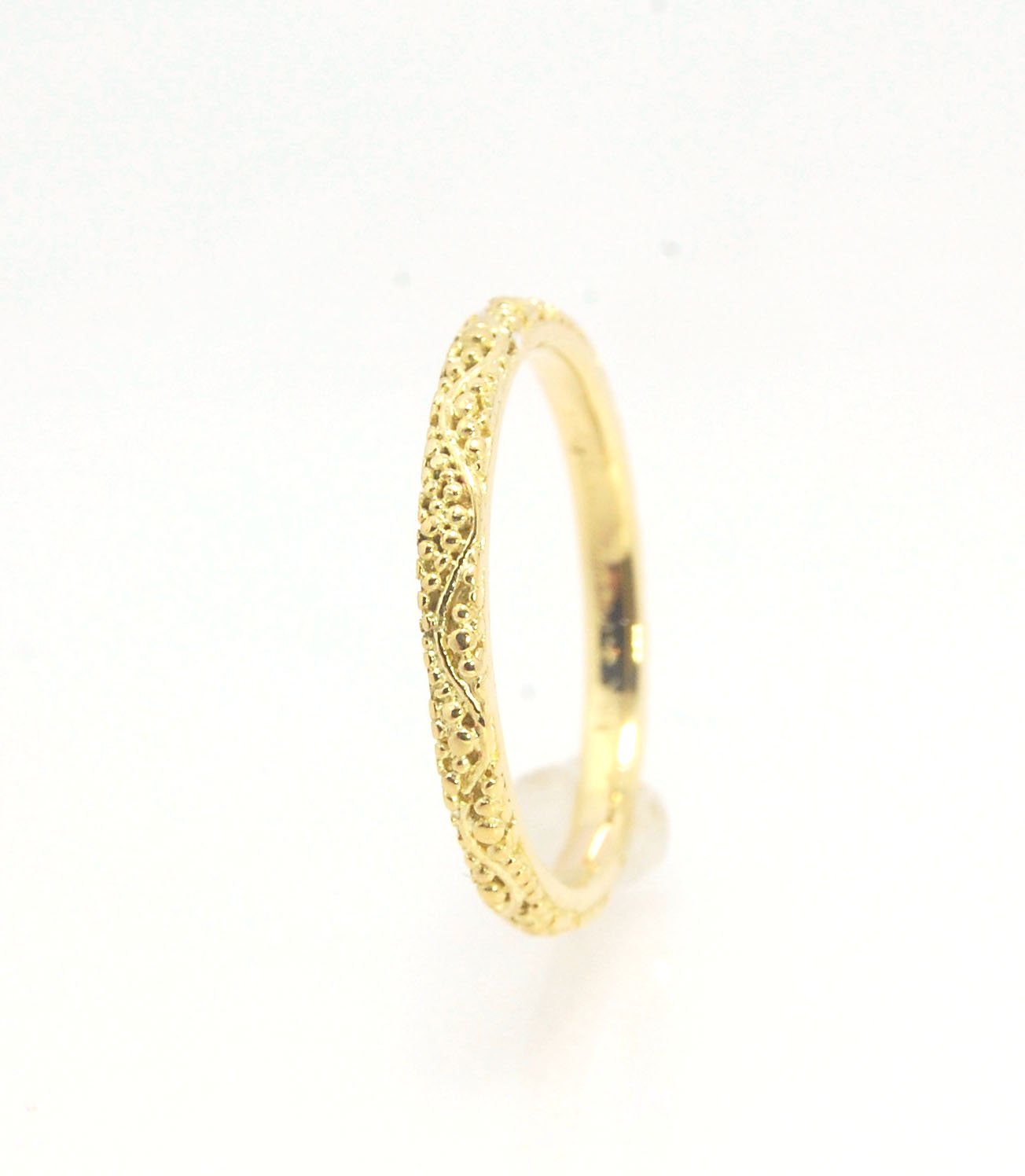 Twining Band in 18k Granulation This is a one-of-a-kind 18k ring handmade using the ancient process of granulation. The twining band is 2mm wide and has a continuous pattern around made with an ancient and unique process of granulation in 18k gold alloyed