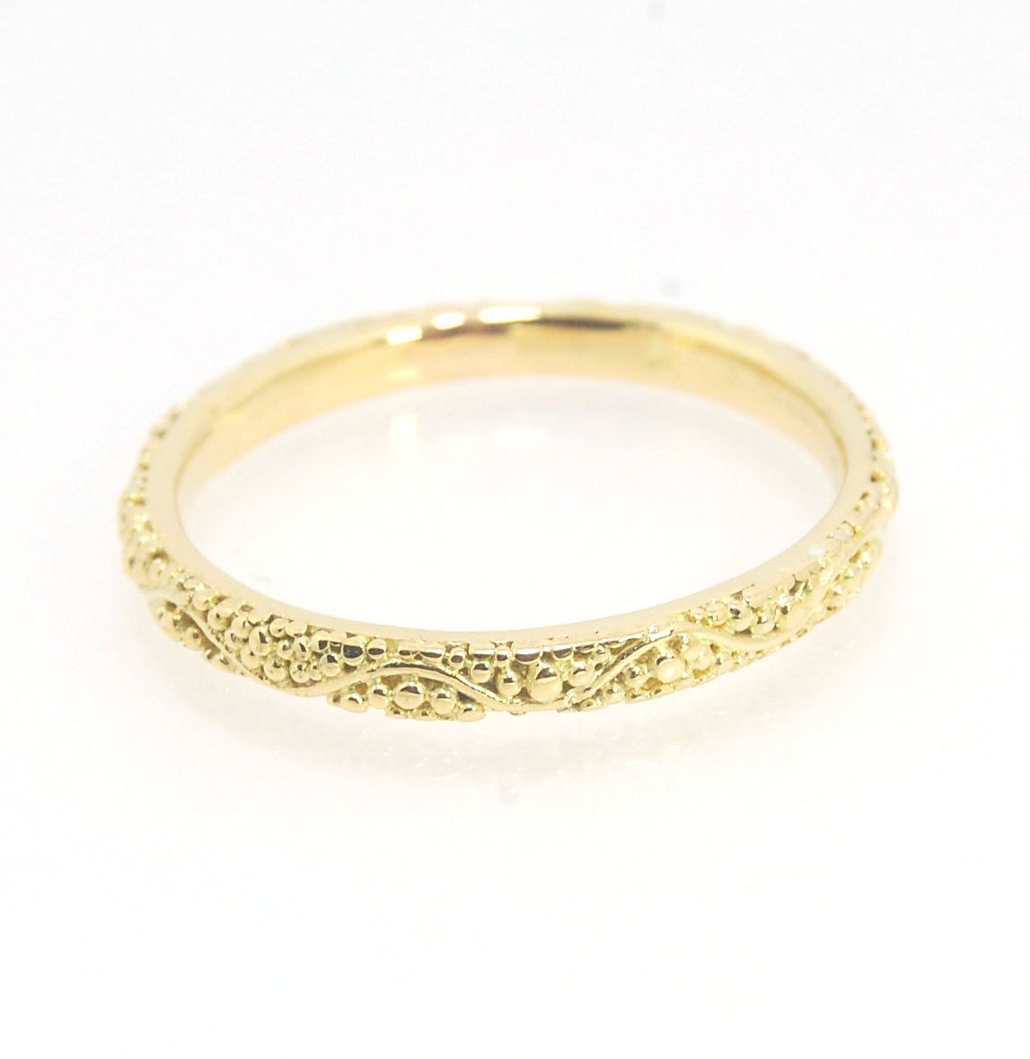 Twining Band in 18k Granulation This is a one-of-a-kind 18k ring handmade using the ancient process of granulation. The twining band is 2mm wide and has a continuous pattern around made with an ancient and unique process of granulation in 18k gold alloyed