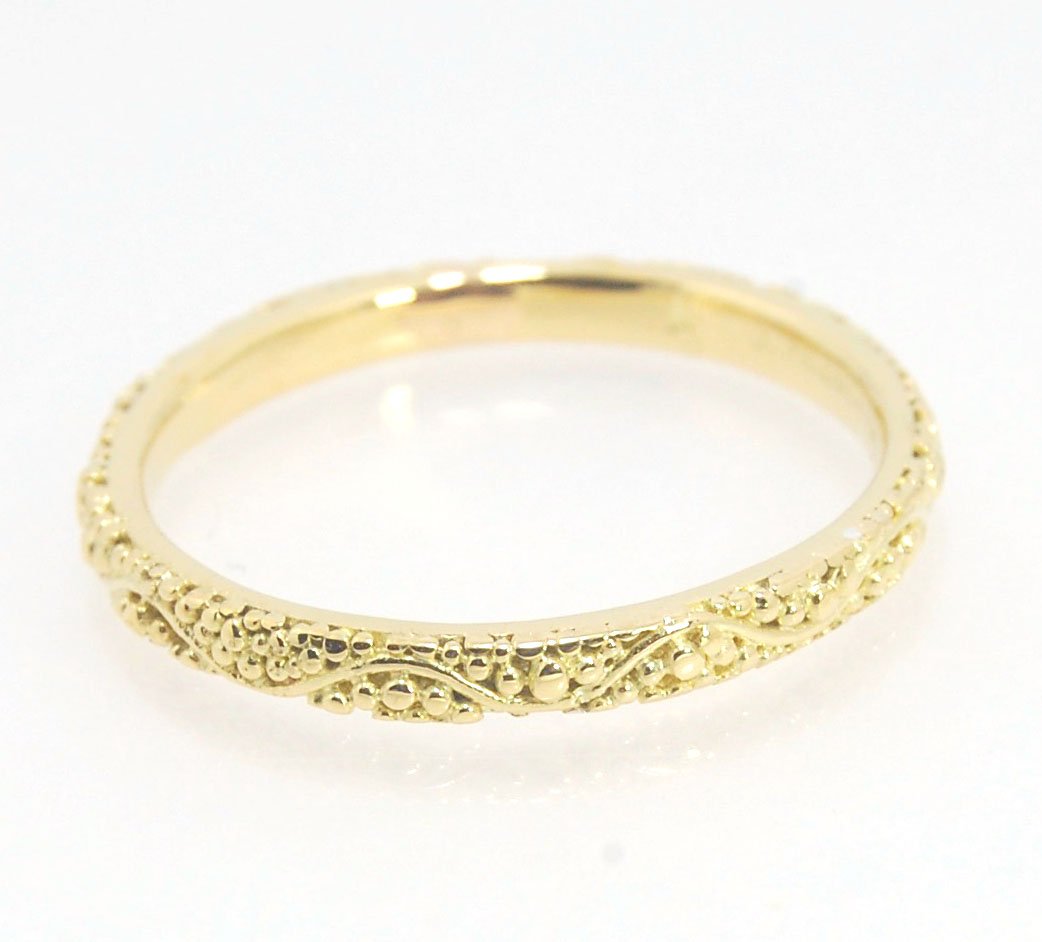 Twining Band in 18k Granulation This is a one-of-a-kind 18k ring handmade using the ancient process of granulation. The twining band is 2mm wide and has a continuous pattern around made with an ancient and unique process of granulation in 18k gold alloyed