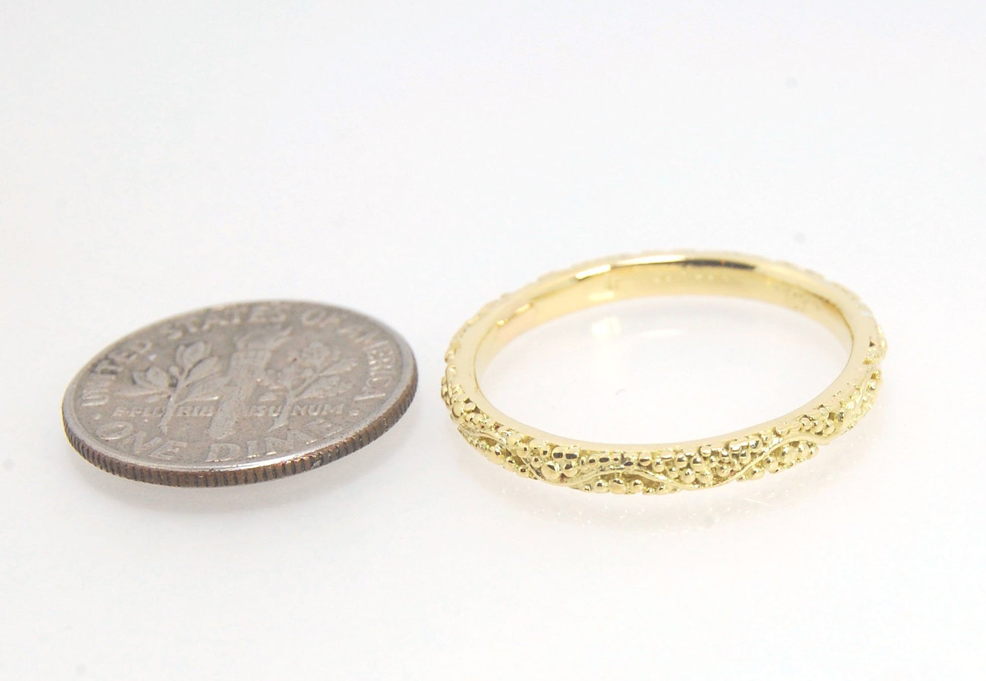 Twining Band in 18k Granulation This is a one-of-a-kind 18k ring handmade using the ancient process of granulation. The twining band is 2mm wide and has a continuous pattern around made with an ancient and unique process of granulation in 18k gold alloyed