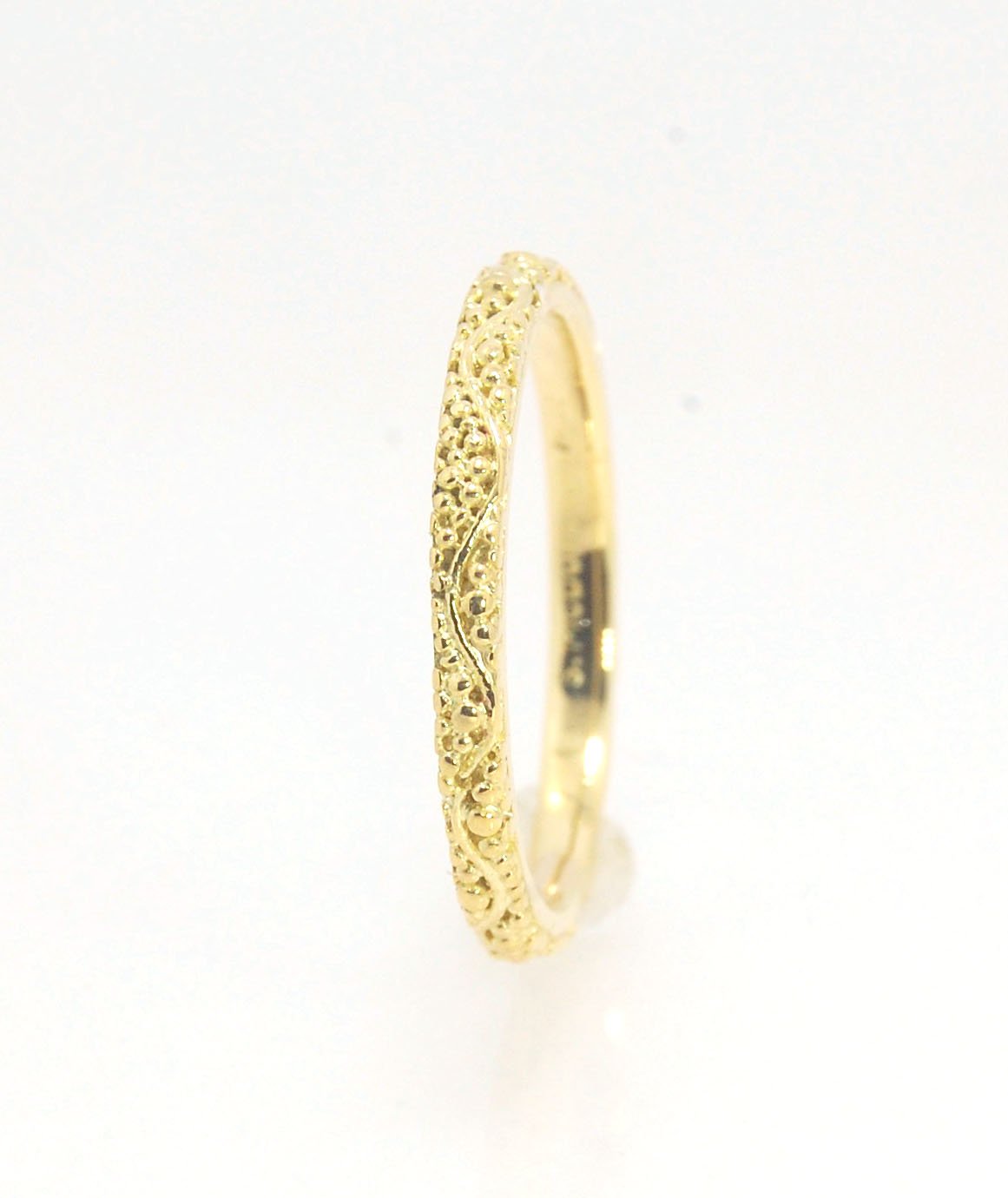 Twining Band in 18k Granulation This is a one-of-a-kind 18k ring handmade using the ancient process of granulation. The twining band is 2mm wide and has a continuous pattern around made with an ancient and unique process of granulation in 18k gold alloyed