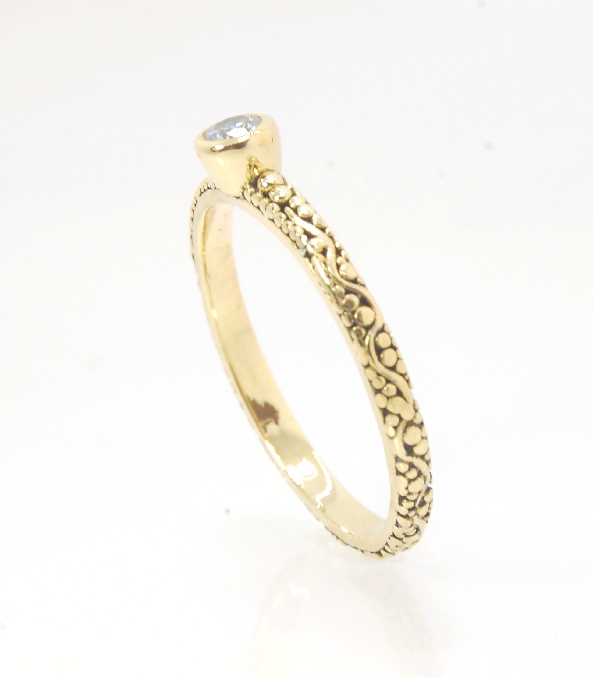 Twining Band Diamond Solitaire Ring in 18k Granulation This is a one-of-a-kind solitaire 18k ring. The twining band is 2mm wide and has a continuous pattern around made with an ancient and unique process of granulation in 18k gold alloyed in my studio. Th