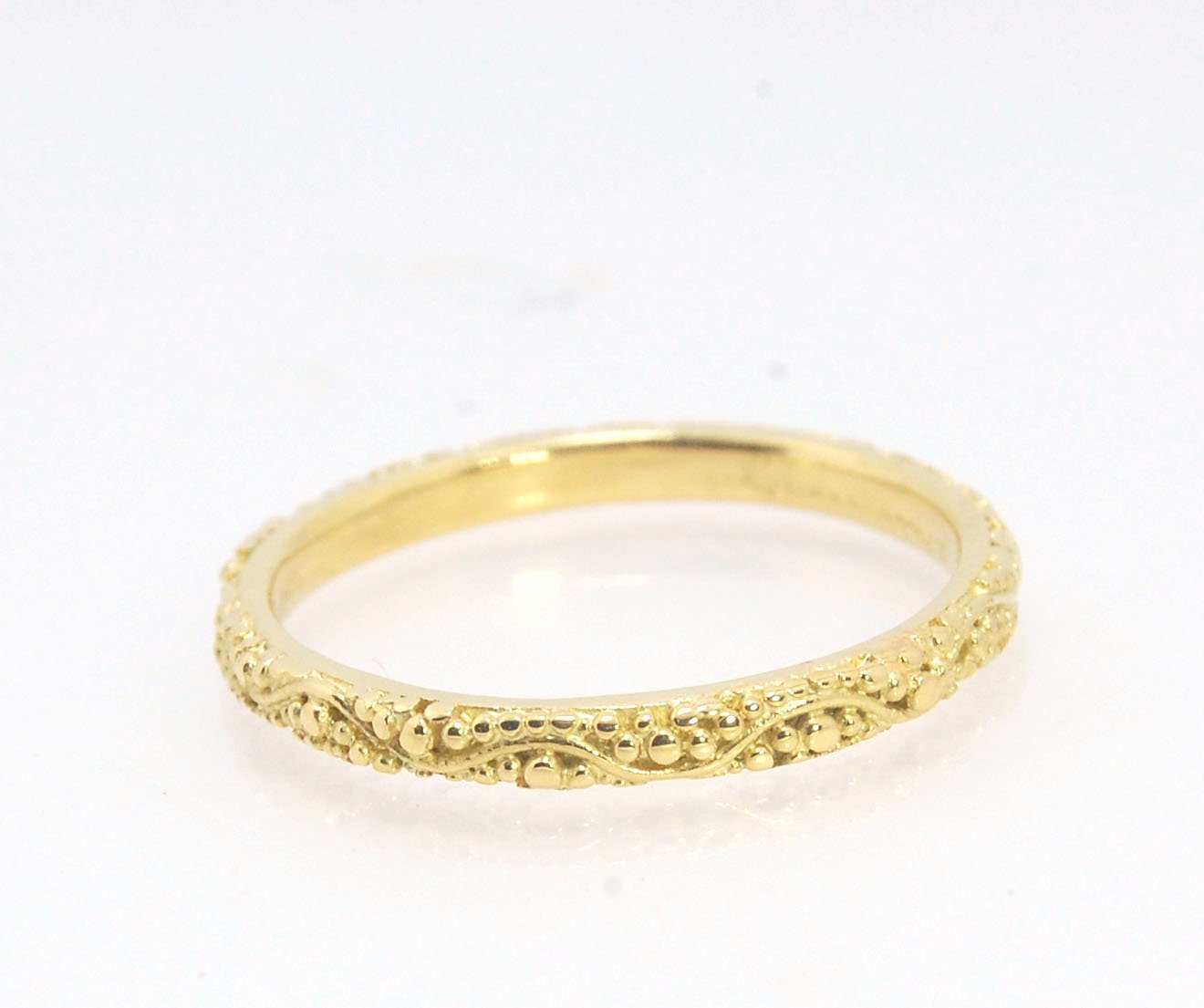 Twining Band in 18k Granulation This is a one-of-a-kind 18k ring handmade using the ancient process of granulation. The twining band is 2mm wide and has a continuous pattern around made with an ancient and unique process of granulation in 18k gold alloyed