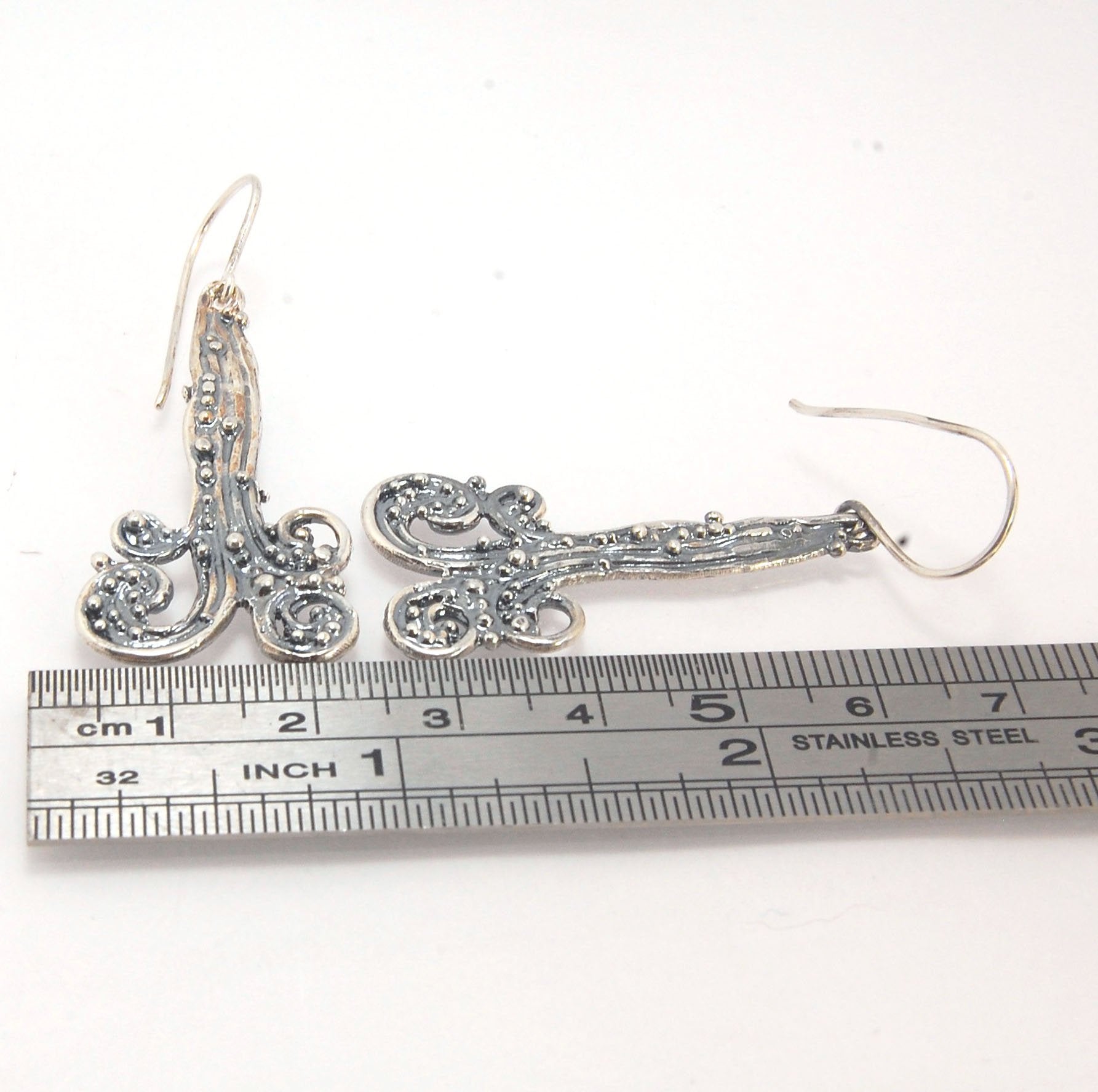 Waterfall Earrings These long Wave Dangles are part of my new work. These are cast versions of my original granulation work, which is then molded for repeat waxes and then cast using the Lost Wax process.These waterfall dangles have a dark patina and are