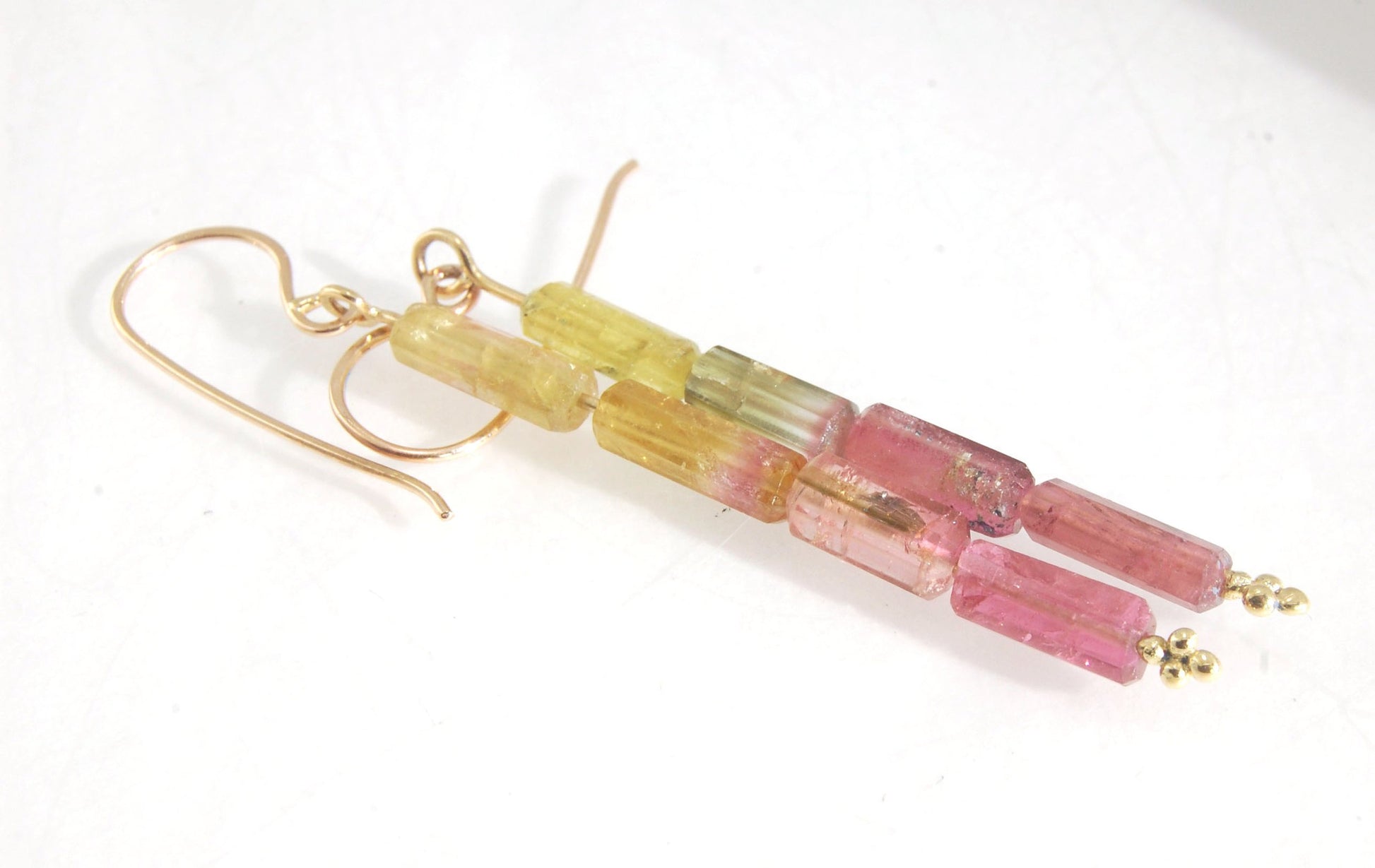 Watermelon Rind Tourmaline Dangle Earrings in 14k gold with french hooks Oh these colors! These Watermelon Rind Tourmaline Dangle Earrings in 14k gold with french hooks are made from faceted slices of natural tourmaline crystals on a 14 pin with 18k spher