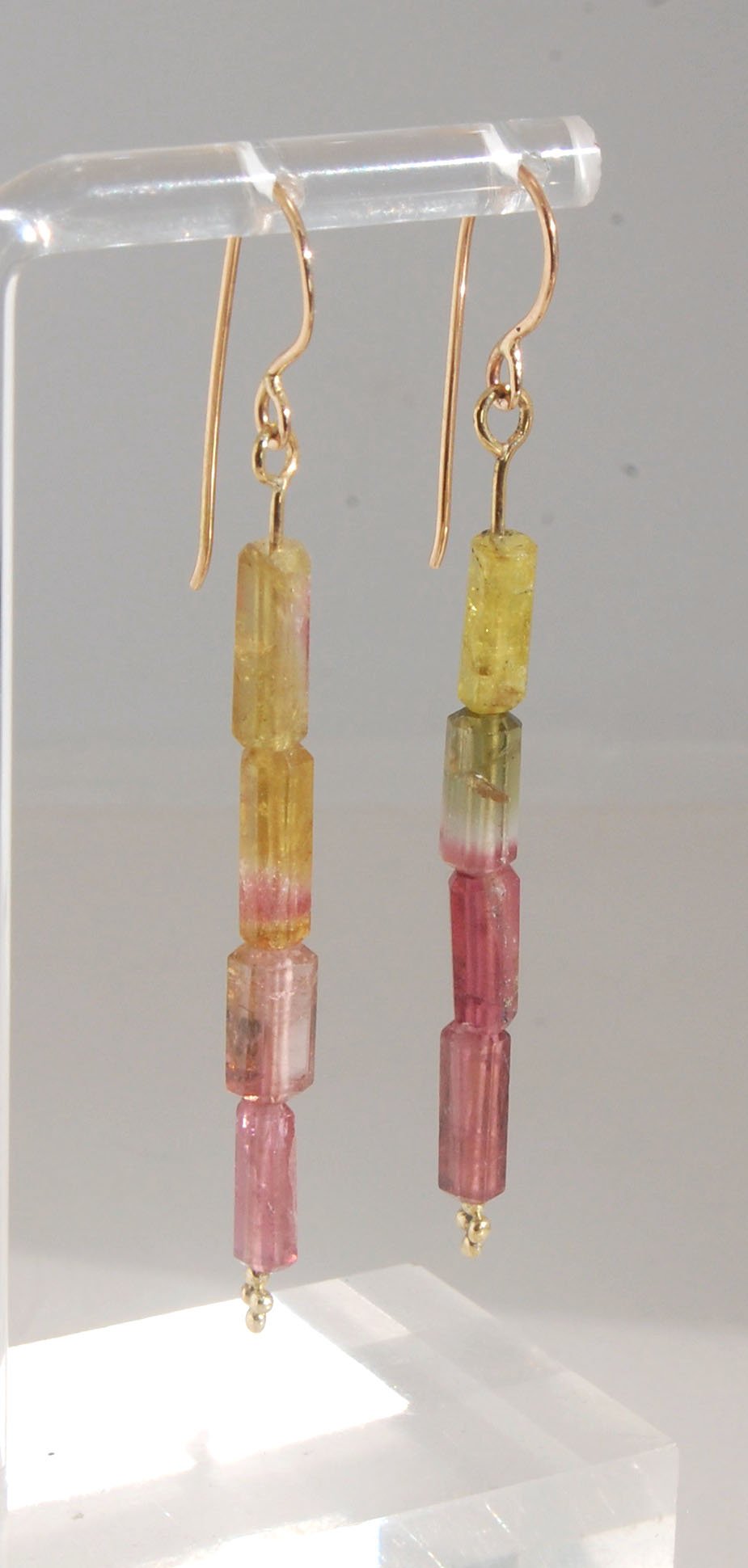 Watermelon Rind Tourmaline Dangle Earrings in 14k gold with french hooks Oh these colors! These Watermelon Rind Tourmaline Dangle Earrings in 14k gold with french hooks are made from faceted slices of natural tourmaline crystals on a 14 pin with 18k spher