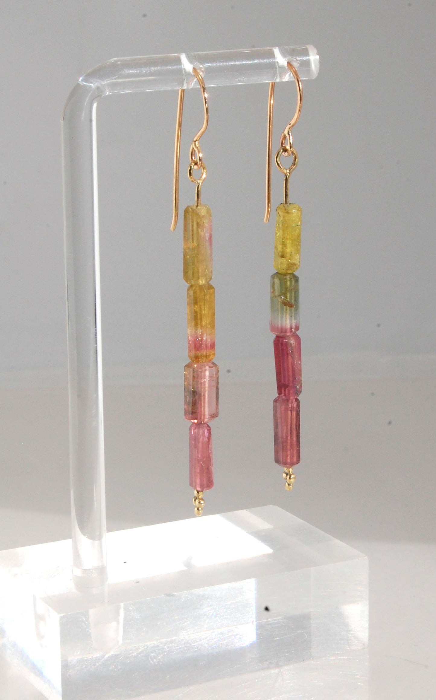 Watermelon Rind Tourmaline Dangle Earrings in 14k gold with french hooks Oh these colors! These Watermelon Rind Tourmaline Dangle Earrings in 14k gold with french hooks are made from faceted slices of natural tourmaline crystals on a 14 pin with 18k spher