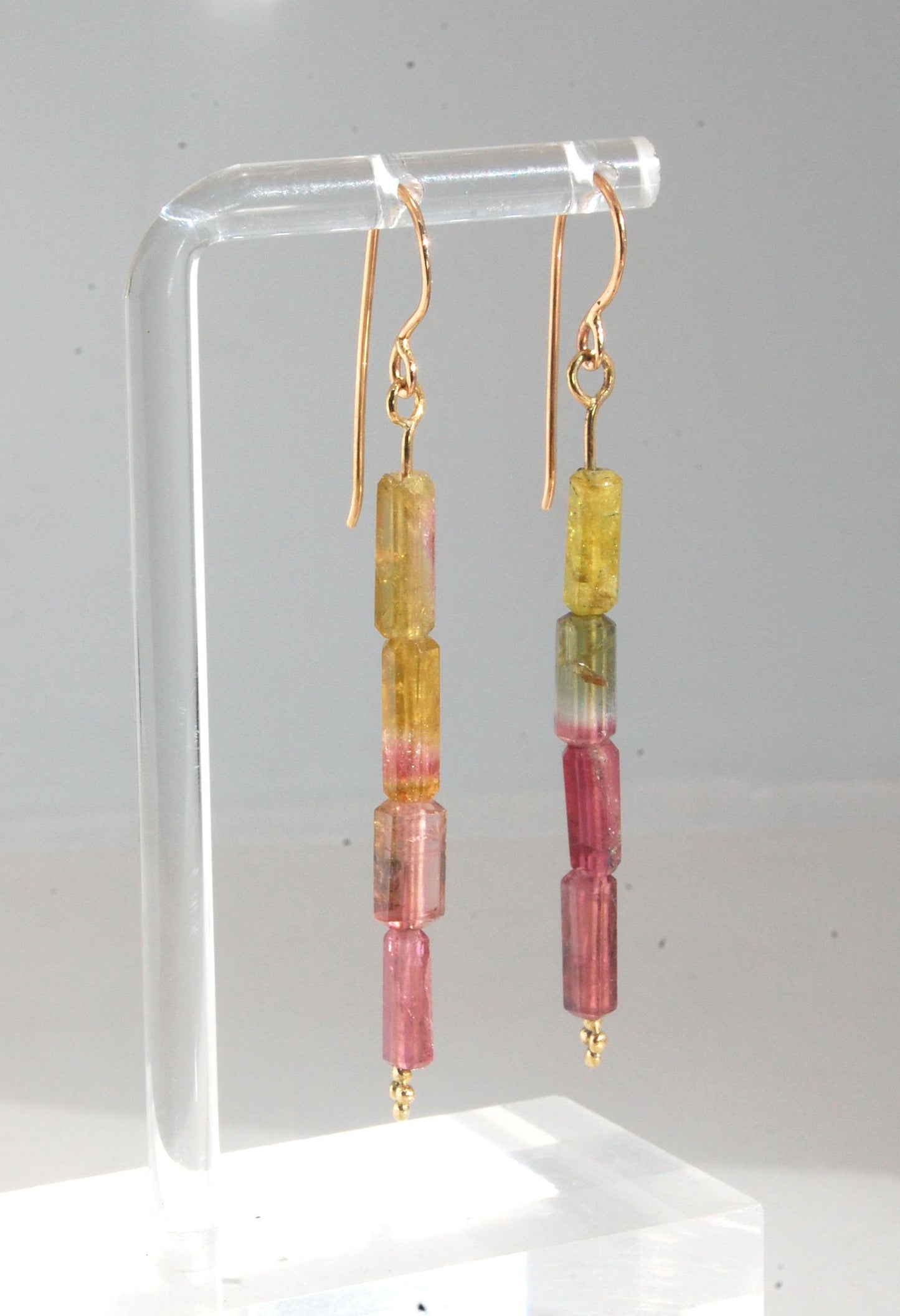 Watermelon Rind Tourmaline Dangle Earrings in 14k gold with french hooks Oh these colors! These Watermelon Rind Tourmaline Dangle Earrings in 14k gold with french hooks are made from faceted slices of natural tourmaline crystals on a 14 pin with 18k spher