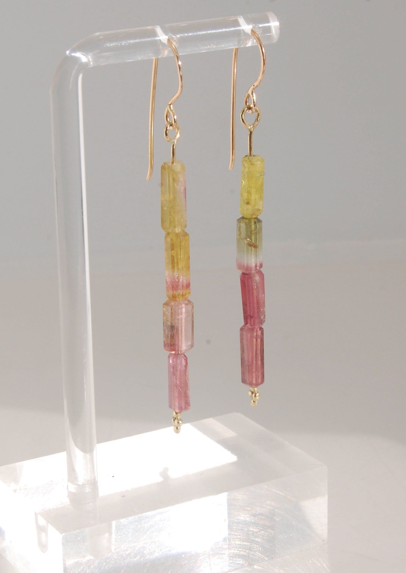 Watermelon Rind Tourmaline Dangle Earrings in 14k gold with french hooks Oh these colors! These Watermelon Rind Tourmaline Dangle Earrings in 14k gold with french hooks are made from faceted slices of natural tourmaline crystals on a 14 pin with 18k spher