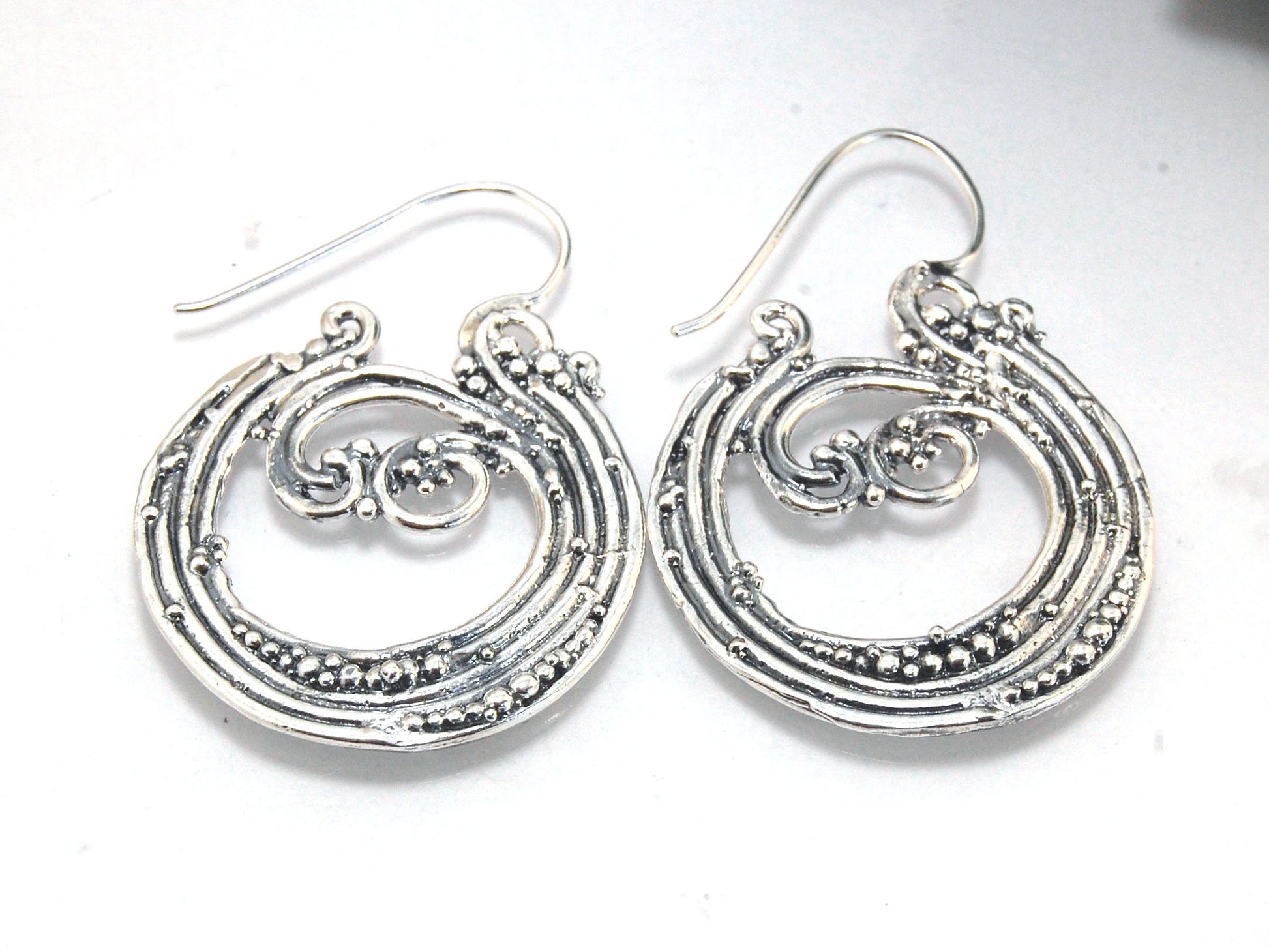 Wave Hoops - Sterling - Large These great Wave Hoops are the Largest of three Waves Hoops. These beauties are cast versions of original fine silver granulation work, which is then molded for repeat waxes and then cast in my studio. Granulation is an ancie