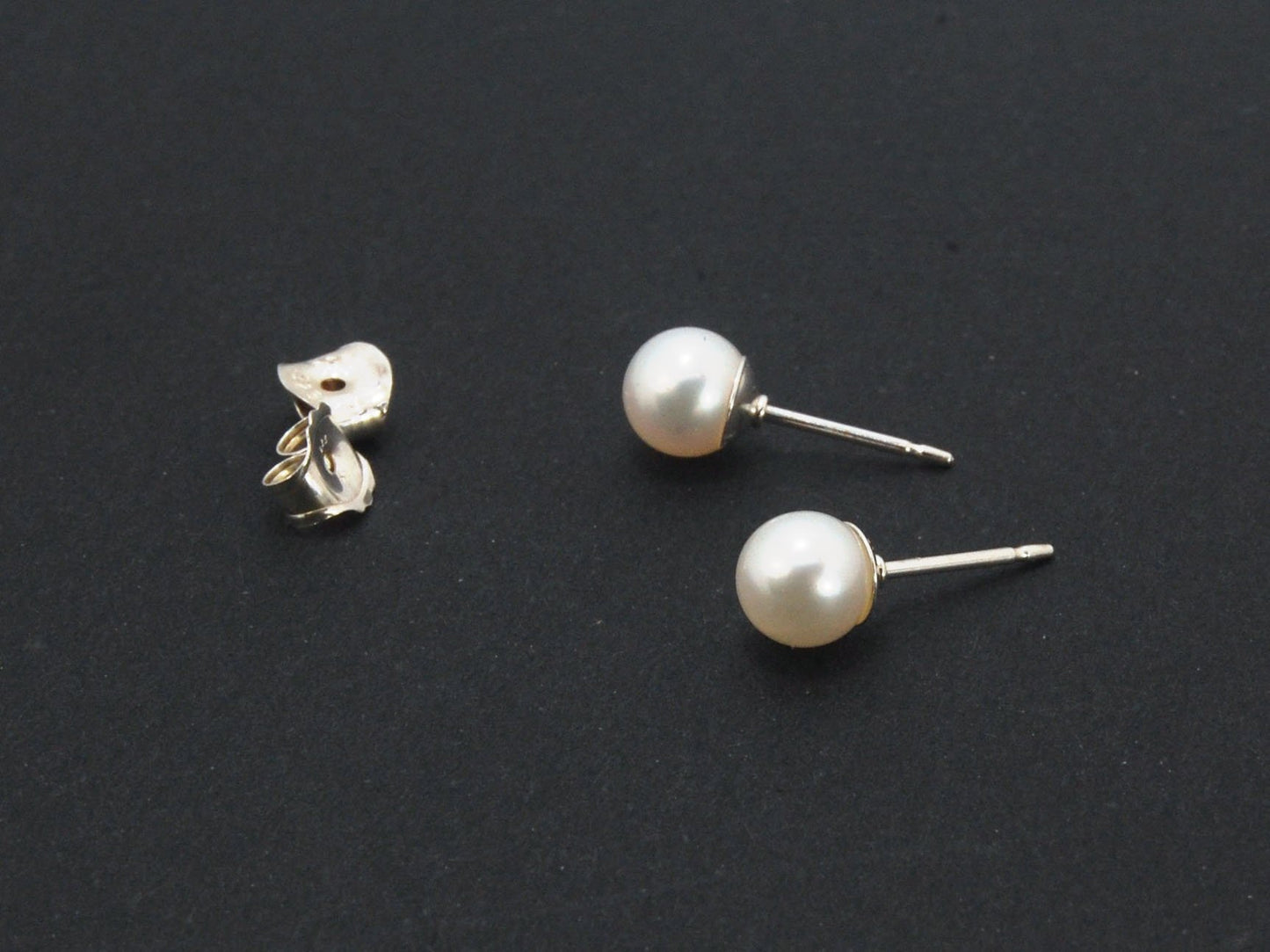 Freshwater White pearls studs in Sterling silver - 6mm These luminous white freshwater pearls are 6mm and set in sterling silver pearl cups and posts with sterling silver ear nuts.6mmSterling Silver and freshwater pearl