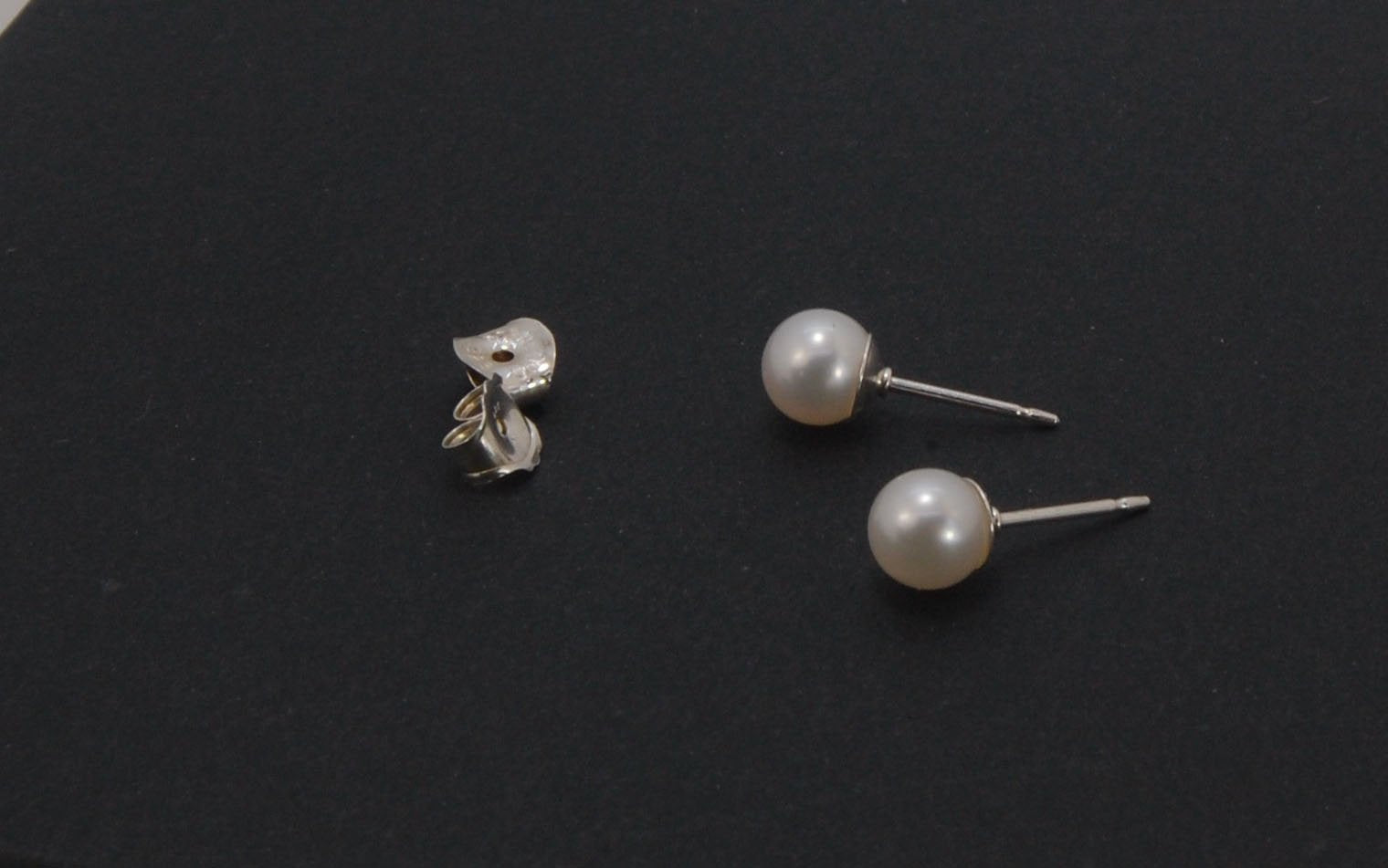 Freshwater White pearls studs in Sterling silver - 6mm These luminous white freshwater pearls are 6mm and set in sterling silver pearl cups and posts with sterling silver ear nuts.6mmSterling Silver and freshwater pearl