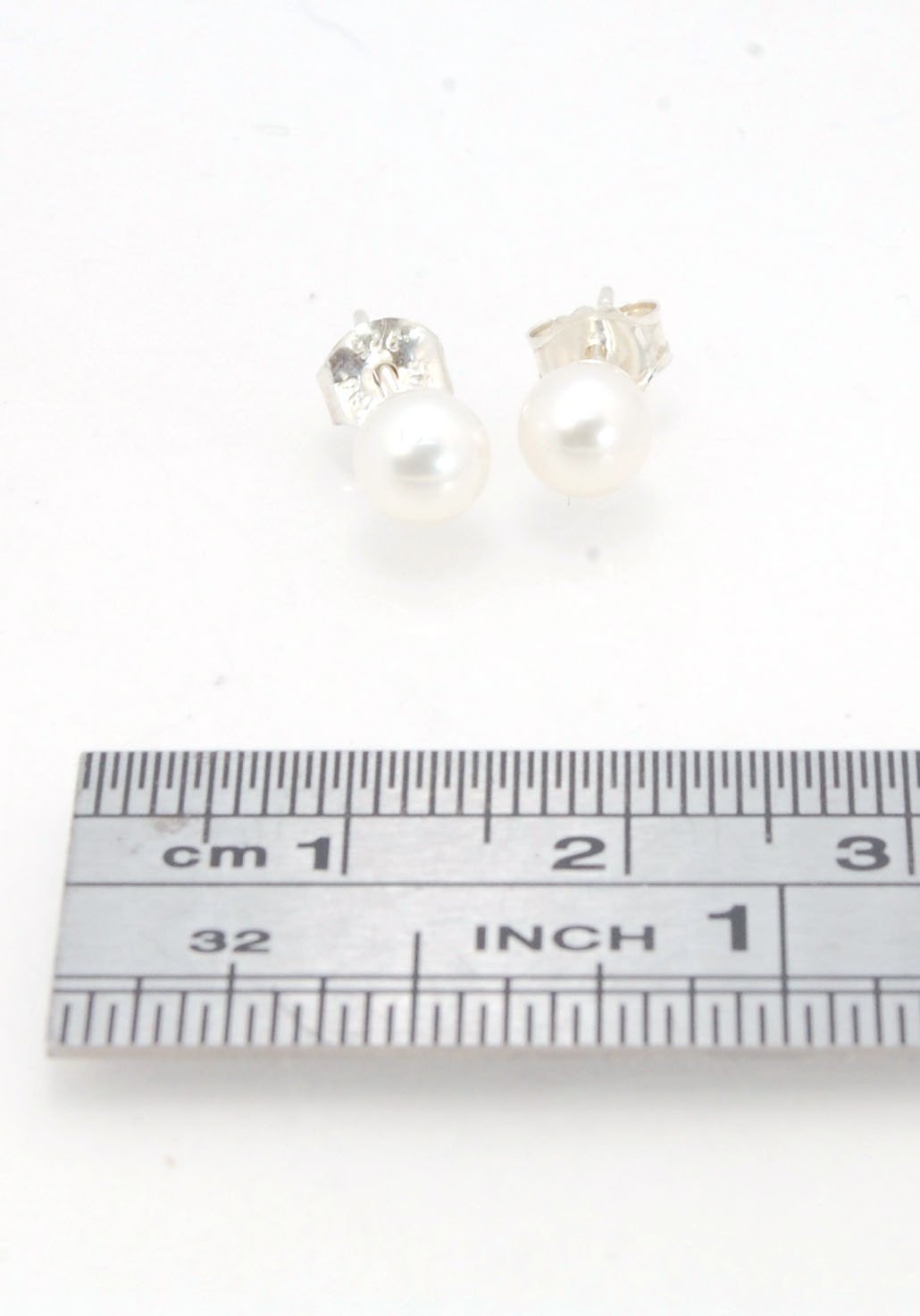 Freshwater White pearls studs in Sterling silver - 6mm These luminous white freshwater pearls are 6mm and set in sterling silver pearl cups and posts with sterling silver ear nuts.6mmSterling Silver and freshwater pearl