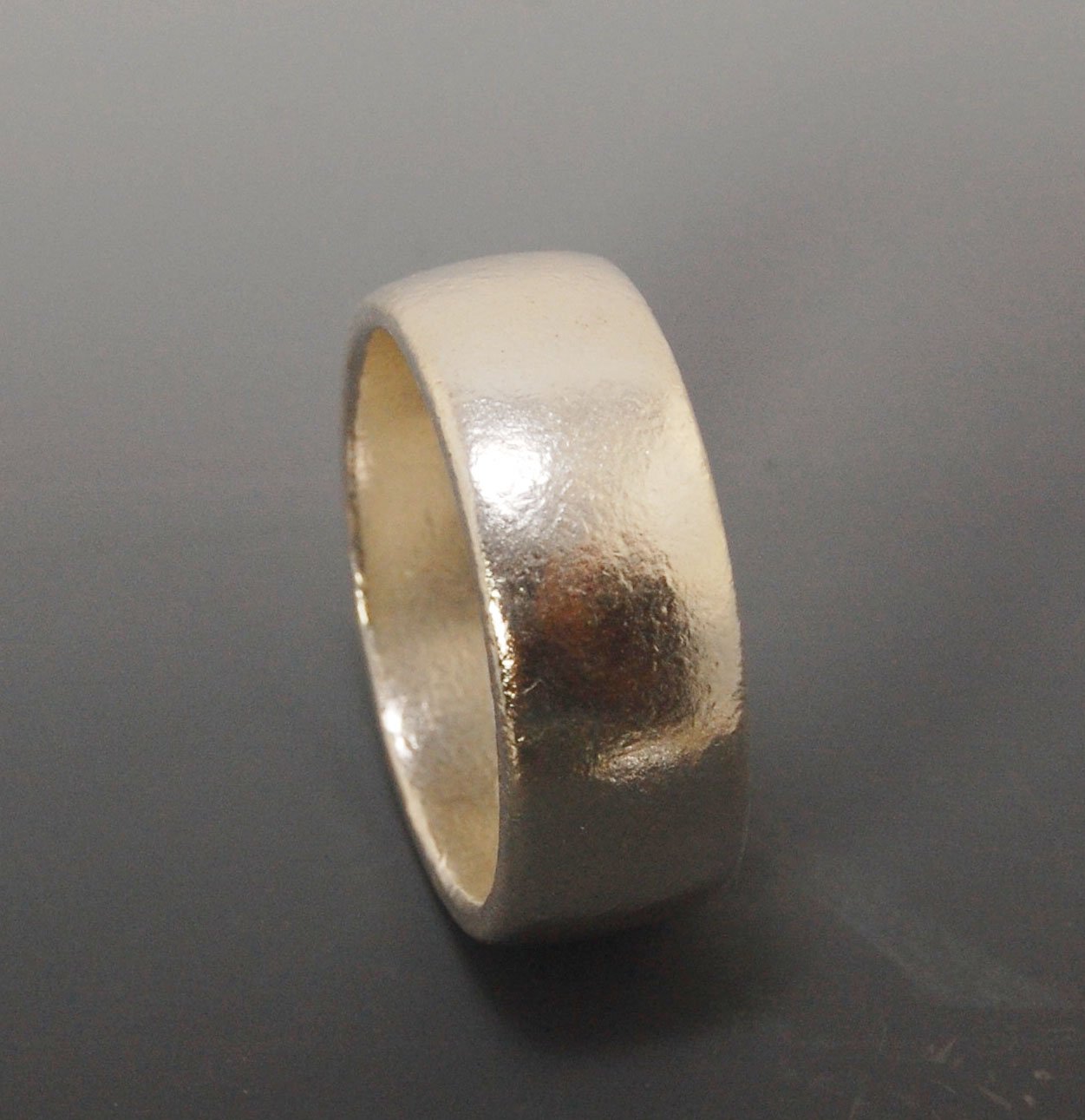 Real Wide Flat Half Round Band Ring in Sterling Silver This is a Real Wide Flat Half Round Band Ring cast from a wax carving. 8mm wide and 2.5mm thick, this ring was turned on a lathe in wax and cast using the lost wax process. These are so much fun to ma