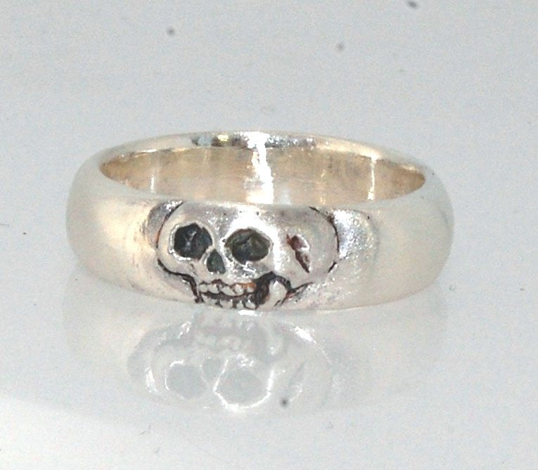 Memento Mori Skull Ring - Wide This is the widest of my Memento Mori skull rings at 7mm. Cast in sterling silver and given a brushed finish after oxidizing the recesses of the skull. Heavyweight, very comfortable.SterlingI made these Memento Mori rings fo