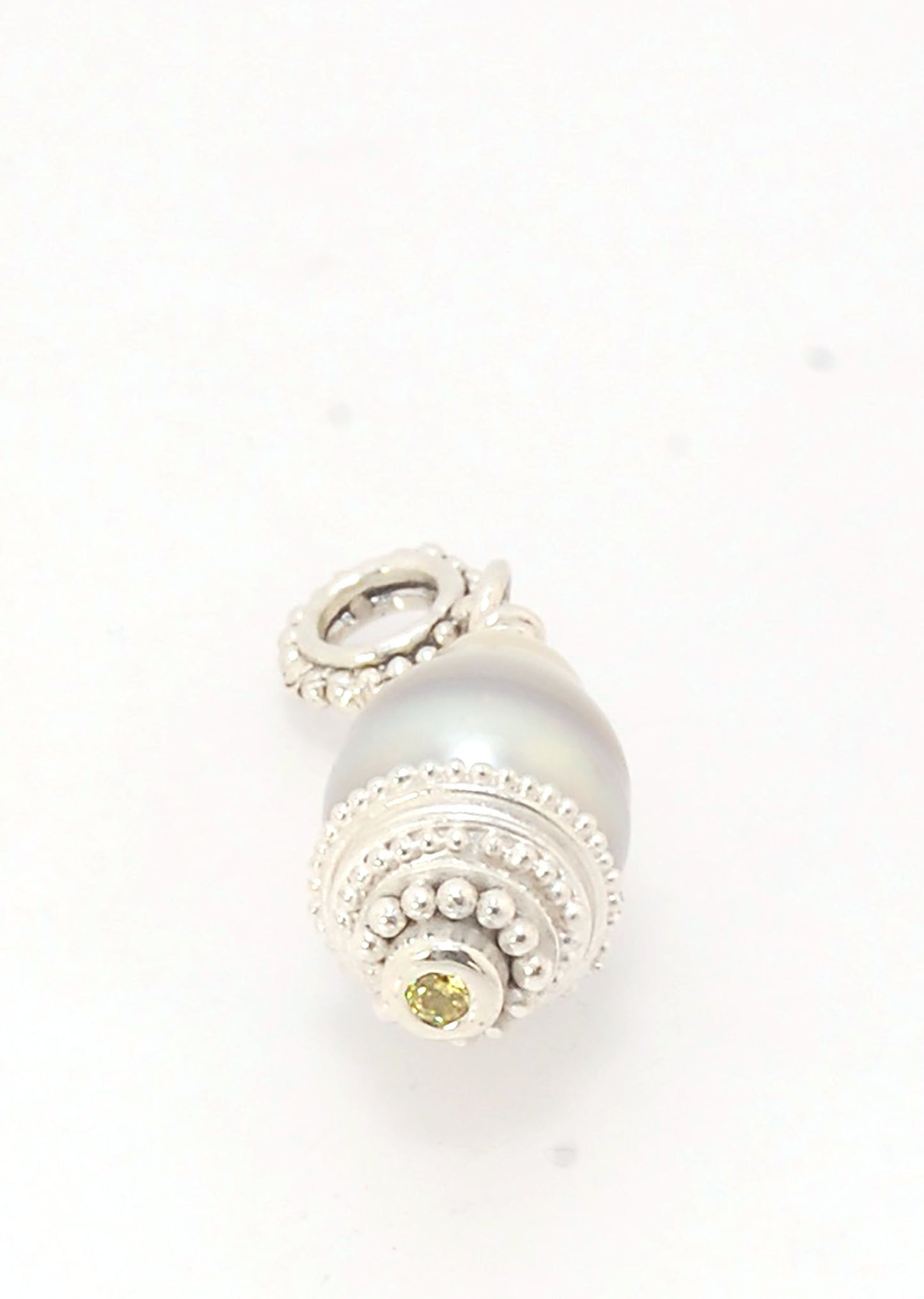 Grey Baroque Pearl with Fine Silver Granulation and Yellow Sapphire Grey Baroque Pearl with Fine Silver Granulation and Yellow SapphireThis grey baroque pearl is capped with one-of-a-kind fine silver granulation and a bezel set 2mm faceted yellow sapphire