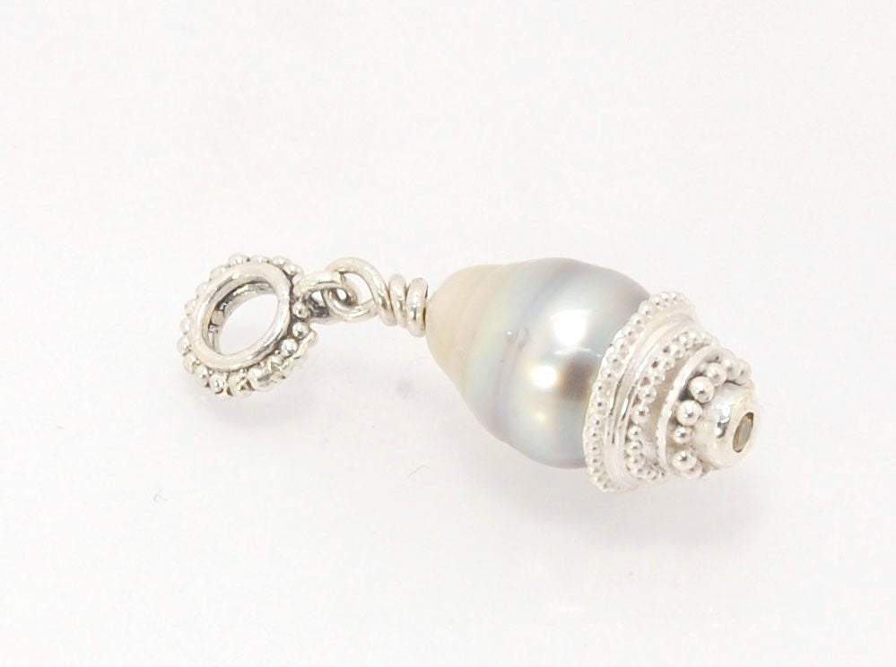 Grey Baroque Pearl with Fine Silver Granulation and Yellow Sapphire Grey Baroque Pearl with Fine Silver Granulation and Yellow SapphireThis grey baroque pearl is capped with one-of-a-kind fine silver granulation and a bezel set 2mm faceted yellow sapphire